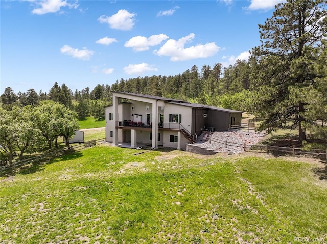 3630 Mesa Verde Rd, Monument, CO 80132 - back of property with stairs, stucco siding, a wooded view, and a wooden deck