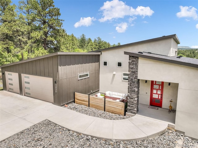 3630 Mesa Verde Rd, Monument, CO 80132 - view of front facade with an outdoor hangout area, concrete driveway, and stucco siding