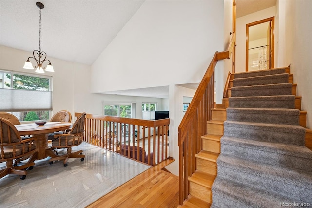 5513 S Yank Ct, Littleton, CO 80127 - stairway with a chandelier and high vaulted ceiling