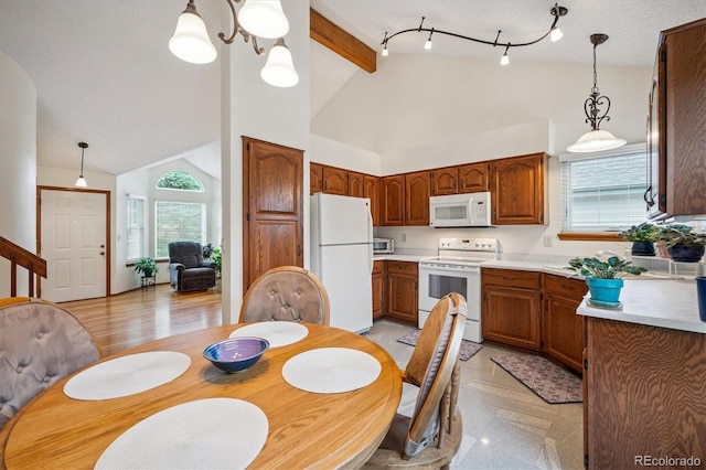 5513 S Yank Ct, Littleton, CO 80127 - kitchen with white appliances, decorative light fixtures, high vaulted ceiling, beamed ceiling, and brown cabinetry