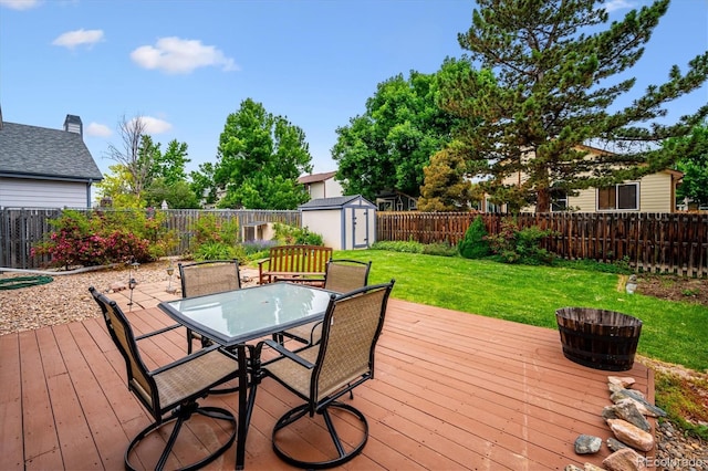 5513 S Yank Ct, Littleton, CO 80127 - deck featuring a storage unit, outdoor dining area, and a fenced backyard
