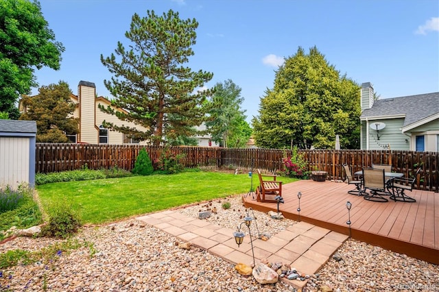 5513 S Yank Ct, Littleton, CO 80127 - deck featuring a fenced backyard, outdoor dining space, and a storage unit