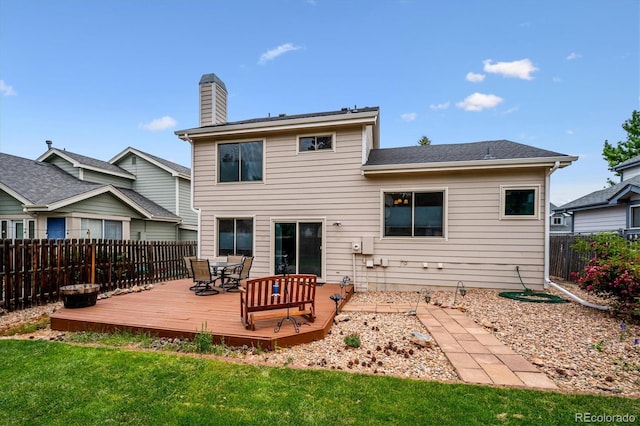 5513 S Yank Ct, Littleton, CO 80127 - back of property featuring a wooden deck, a fenced backyard, a chimney, and outdoor dining area
