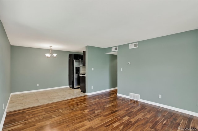 10211 Ura Ln Unit 208, Thornton, CO 80260 - unfurnished room with wood finished floors and a chandelier
