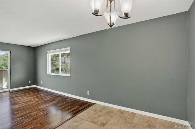 10211 Ura Ln Unit 208, Thornton, CO 80260 - spare room with a chandelier and wood finished floors