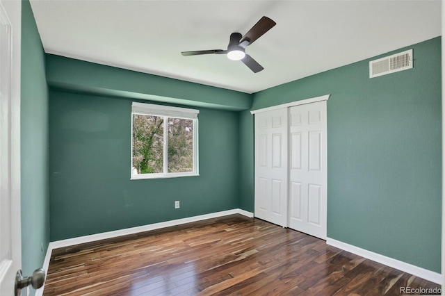 10211 Ura Ln Unit 208, Thornton, CO 80260 - unfurnished bedroom featuring dark wood-type flooring, a closet, and a ceiling fan