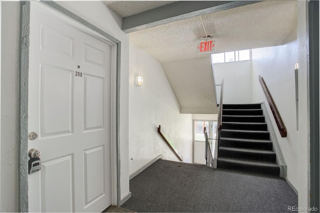 10211 Ura Ln Unit 208, Thornton, CO 80260 - stairs featuring a textured ceiling, vaulted ceiling, and carpet flooring