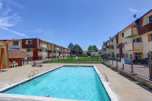 10211 Ura Ln Unit 208, Thornton, CO 80260 - community pool featuring a residential view and a patio area