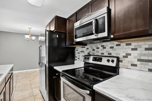 10211 Ura Ln Unit 208, Thornton, CO 80260 - kitchen featuring stainless steel appliances, backsplash, dark brown cabinets, and a chandelier