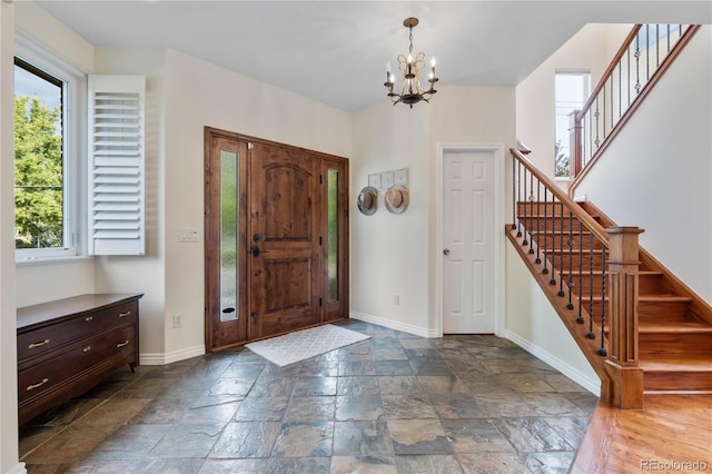 entryway featuring an inviting chandelier