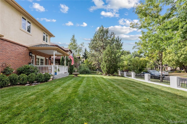 view of yard with covered porch