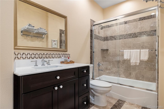 full bathroom with vanity, enclosed tub / shower combo, and toilet