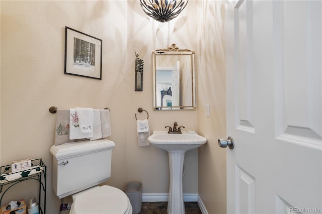 bathroom featuring toilet and sink