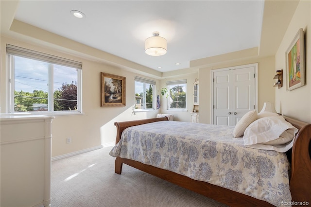 bedroom with light carpet and a closet