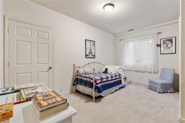 carpeted bedroom with a textured ceiling