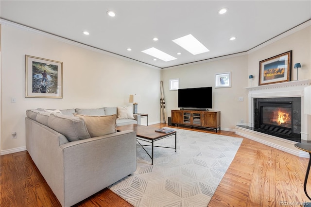 2400 S Clayton St, Denver, CO 80210 - living room with crown molding, a glass covered fireplace, baseboards, recessed lighting, and wood finished floors