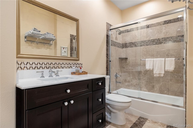 2400 S Clayton St, Denver, CO 80210 - full bath featuring toilet, shower / bath combination with glass door, vanity, and tasteful backsplash