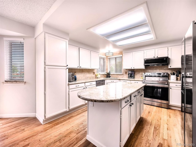 kitchen with white cabinetry, appliances with stainless steel finishes, a sink, and light wood-style flooring