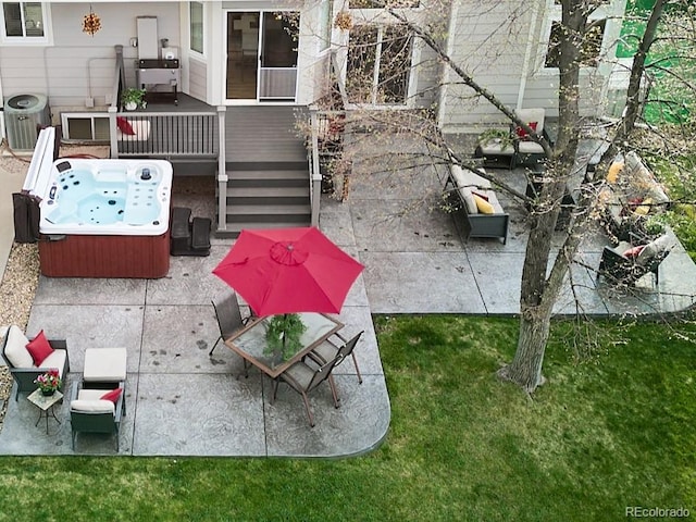 view of patio featuring a hot tub, central AC, and a deck