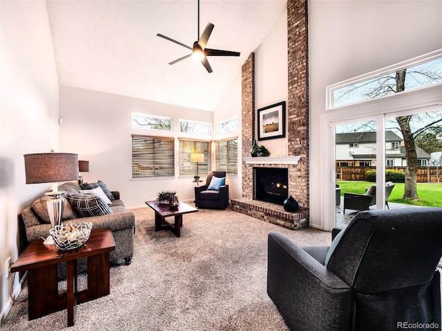 living room featuring carpet floors, a fireplace, baseboards, ceiling fan, and high vaulted ceiling