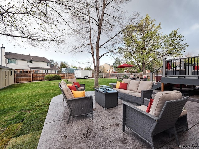 view of patio with a storage shed, an outdoor living space, and a fenced backyard
