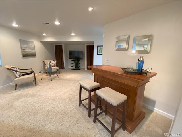 bar featuring light colored carpet, baseboards, visible vents, and a dry bar
