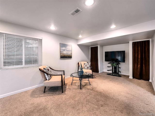 living area featuring carpet flooring, baseboards, and visible vents