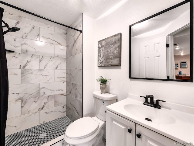 bathroom with vanity, toilet, and a stall shower