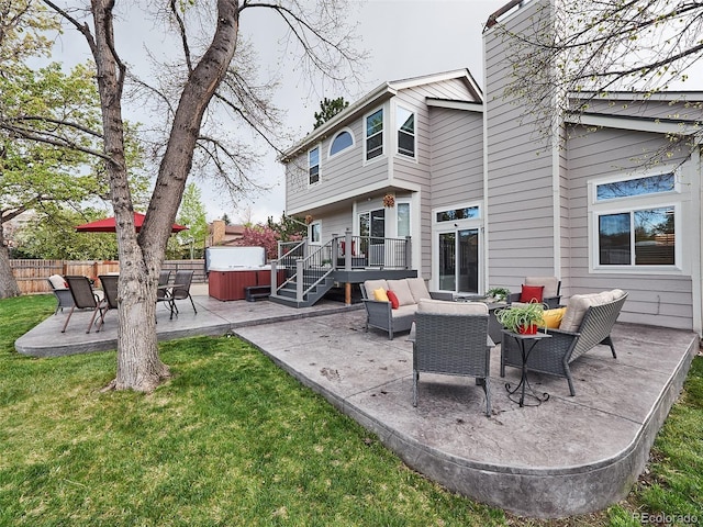 rear view of property featuring an outdoor living space, a patio area, a hot tub, fence, and a yard