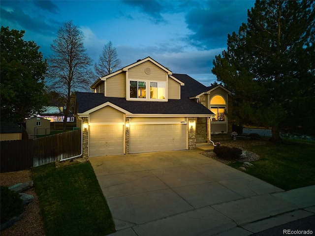view of front of property with a garage, fence, a front yard, roof with shingles, and driveway