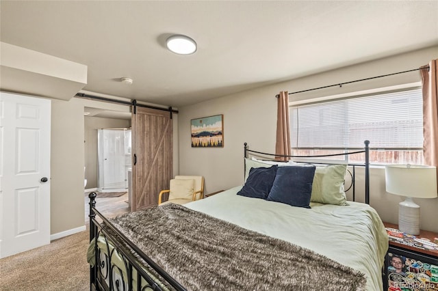 bedroom with a barn door and light carpet