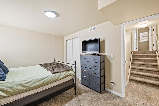 bedroom with light colored carpet and a closet