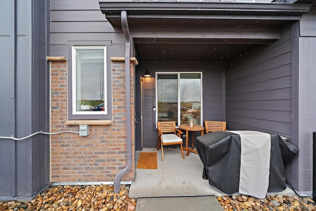 property entrance featuring brick siding