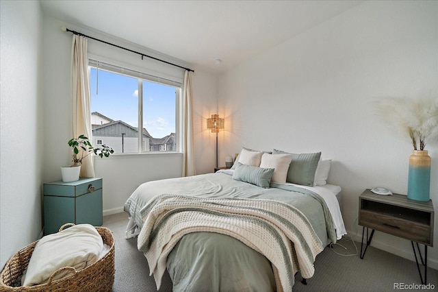 carpeted bedroom featuring baseboards