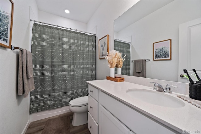 bathroom with wood finished floors, toilet, vanity, and a shower with shower curtain