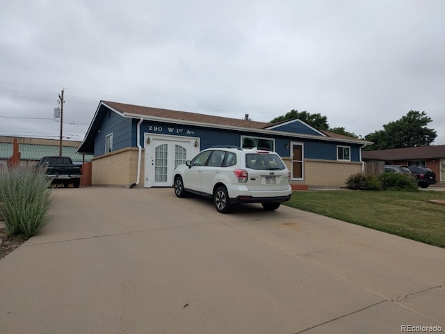 290 W 1st Ave, Broomfield, CO 80020 - single story home featuring driveway, a front yard, and brick siding