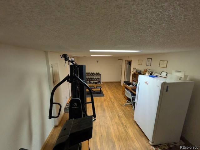 290 W 1st Ave, Broomfield, CO 80020 - workout room featuring light wood-style flooring and a textured ceiling