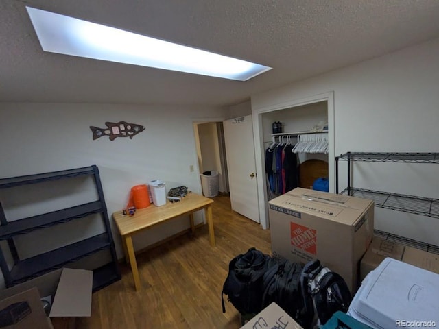 290 W 1st Ave, Broomfield, CO 80020 - bedroom featuring a textured ceiling, wood finished floors, and a closet