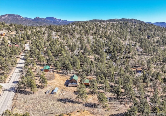 aerial view with a wooded view and a mountain view