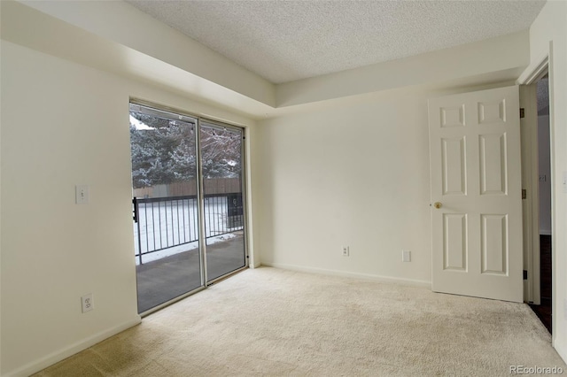 carpeted empty room with a textured ceiling