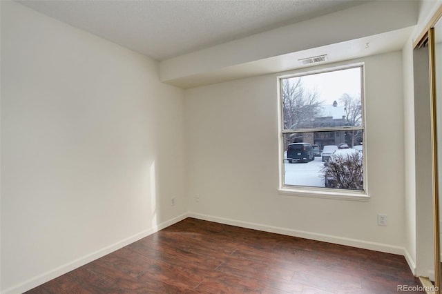 spare room featuring dark hardwood / wood-style floors