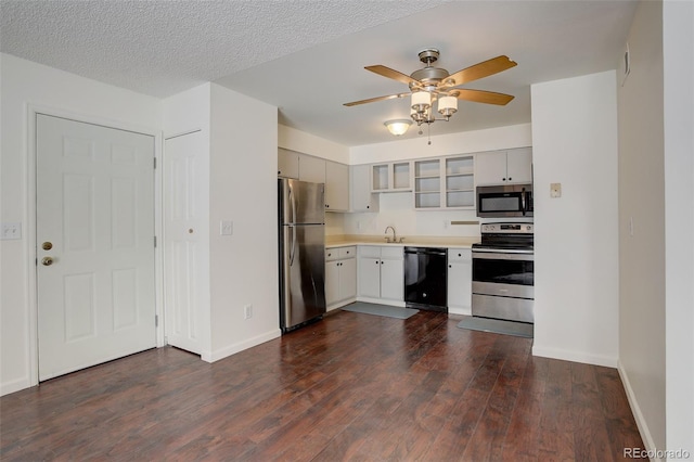 kitchen with sink, ceiling fan, a textured ceiling, dark hardwood / wood-style flooring, and stainless steel appliances