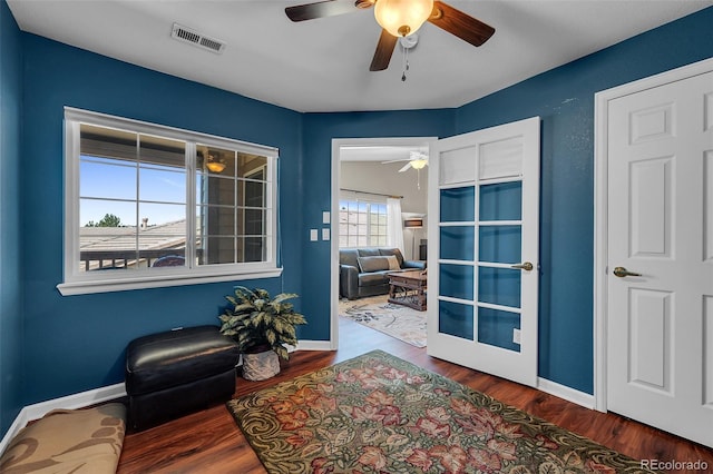 sitting room with hardwood / wood-style floors and ceiling fan