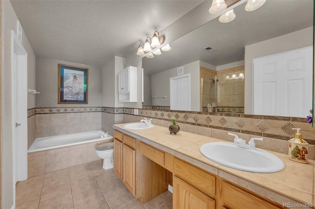 full bathroom featuring a textured ceiling, toilet, vanity, plus walk in shower, and tile patterned flooring