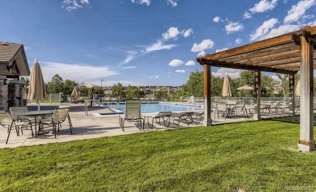 view of swimming pool with a yard, a patio area, and a pergola