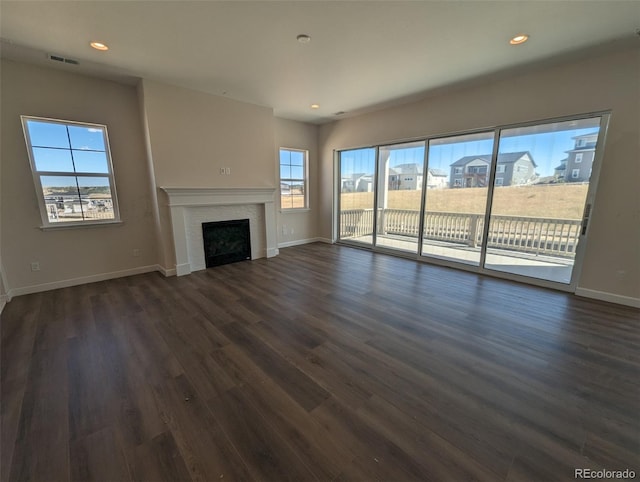 unfurnished living room with dark wood-type flooring