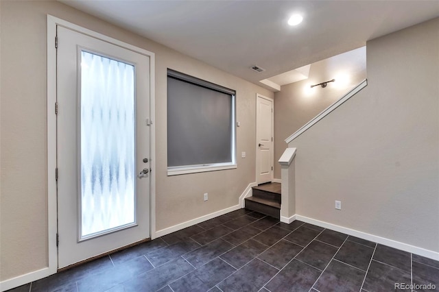 entryway featuring dark tile patterned flooring