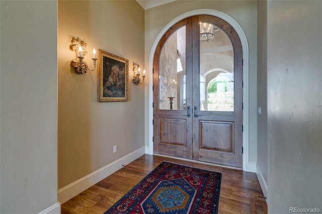 entryway with dark hardwood / wood-style floors and french doors