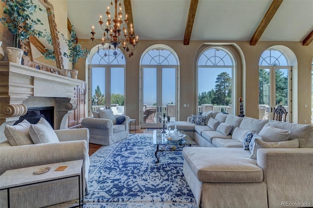 living room with beamed ceiling, a wealth of natural light, a premium fireplace, and french doors