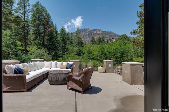 view of patio with a mountain view and outdoor lounge area